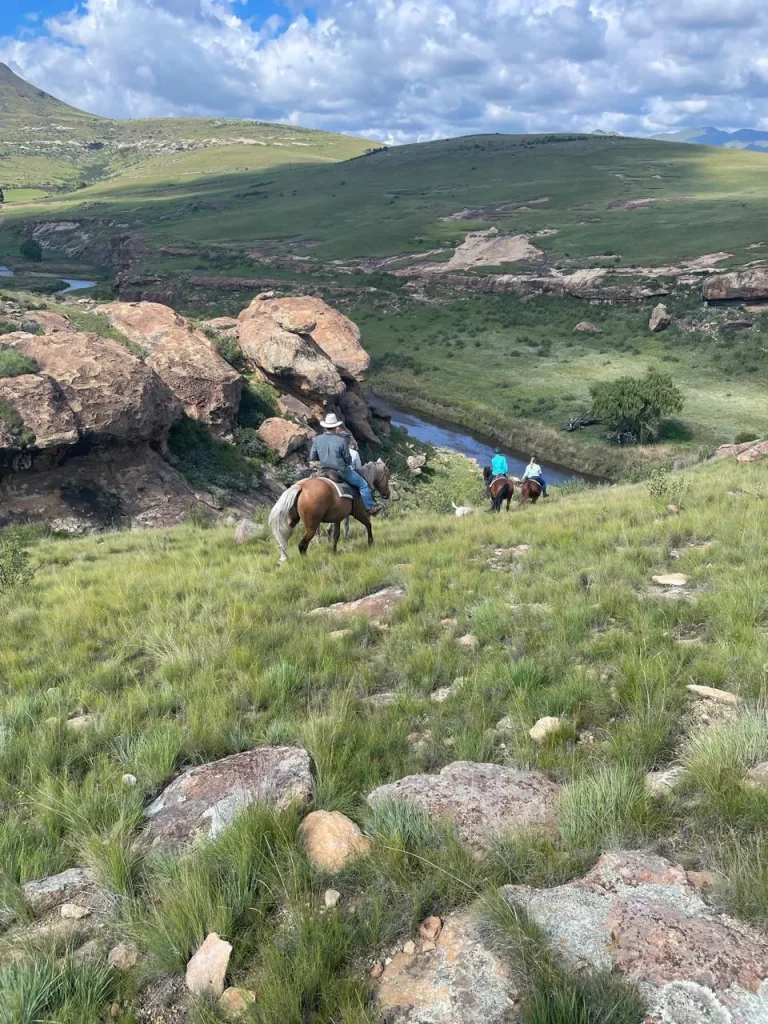 Riders heading down to the river on a Steepside horse ride